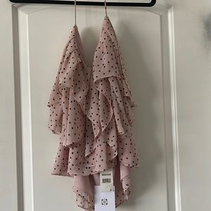 Flouncy pink and black polka dots top with shoulder tie